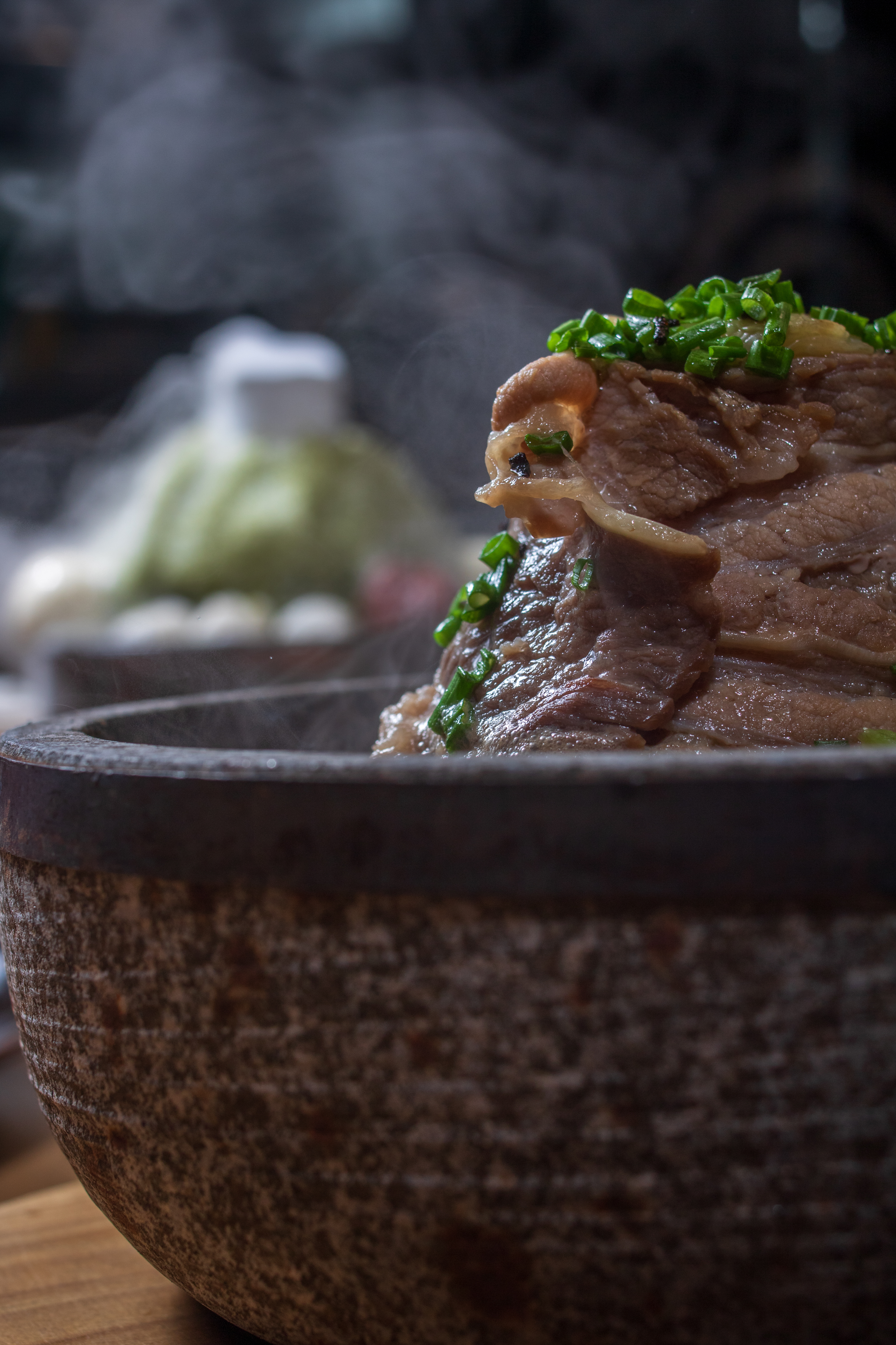 Steaming Kazan stone-bowl ramen topped with sliced chashu